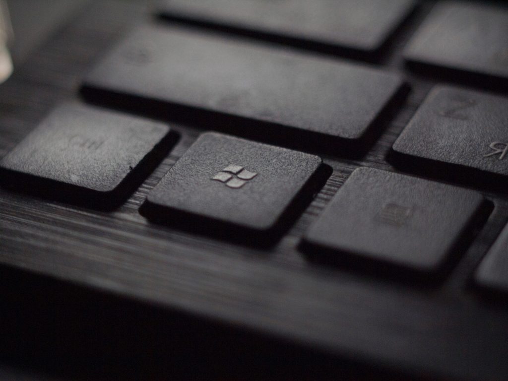 close up picture of the windows key on a laptop